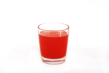 Fresh grapefruit juice with mint in a glass cup isolated on white background. Grapefruit fresh and juice on a white background, view of the shu, cospore space