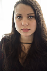 Beautiful Young Woman Standing in Front of a Window.