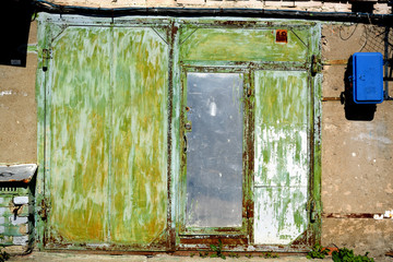 Garage with old metal gates of unusual green color.