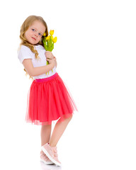 Little girl with a bouquet of tulips.
