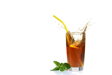 Splashes from a glass of cold tea with lemon.