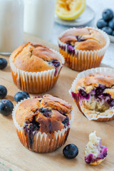 Homemade blueberry and lemon muffins on wooden board