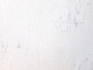shabby old flaky plaster wall background. white damaged crackled paint. weathered worn out surface....