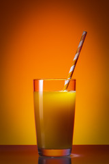 Orange juice glass on white background
