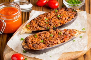 Stuffed eggplant, aubergine, ground beef, pork, vegetables, tomato sauce, rustic style