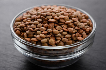 raw lentils on a dark stone background