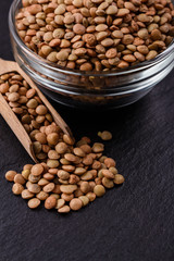 raw lentils on a dark stone background