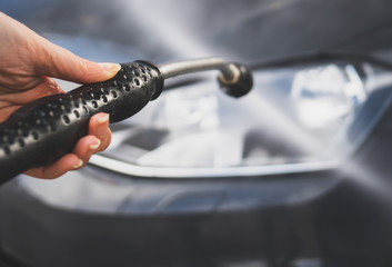 Car wash using high pressure water jet.