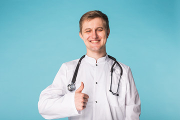 Medical physician doctor man showing thumbs up over blue background