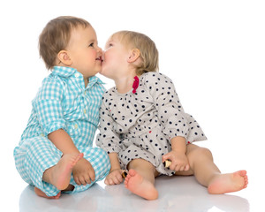 Babies boys and a girl cute embrace.