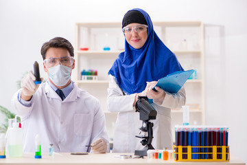 Two chemists working in the lab