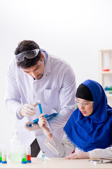 Two chemists working in the lab