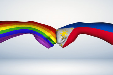 Fist bump of Filipino flag and Pride Flag. 
Two hands with painted flags of the Philippines and...