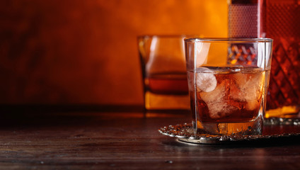 Glass of scotch whiskey and natural ice .