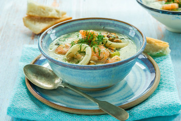 Creamy seafood stew garnished with fresh dill