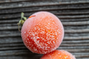 frozen cherry tomatoes. on wood background, top view, macro - 208806040