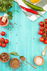 food frame, turquoise background, red vegetables and spices, hot pepper