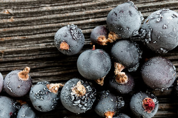 frozen black currant berries on wooden background, top view, macro - 208806462