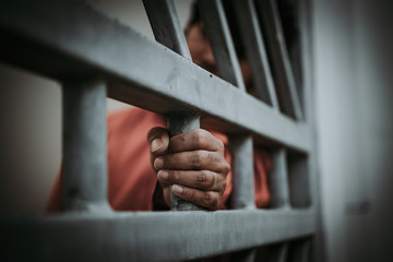 Hands of men desperate to catch the iron prison,prisoner concept,thailand people,Hope to be free,A person guilty are punished.