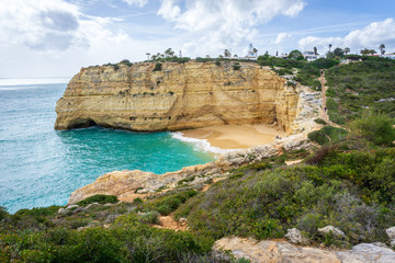 Fototapeta na wymiar View of beautiful Marinha beach with crystal clear turquoise water near Carvoeiro town, Algarve region, Portugal