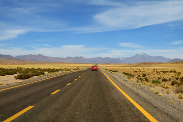 Fototapeta na wymiar Driving on the high altitude desert road of Atacama desert in northern Chile, South America 