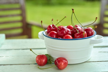 Bowl full of fresh cherries on a rustic table