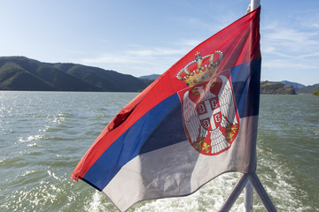 Flag of Serbia on the deck of a boat Danube River, Svinita, Mehedinti County, Oltenia, Romania