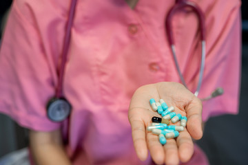 Colorful pills and medicines in the hand