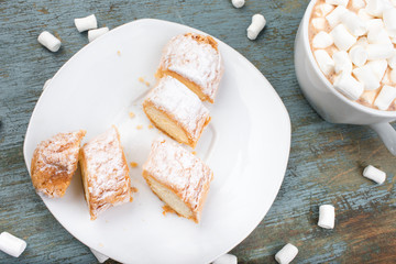 Cocoa with marshmallow and cake.