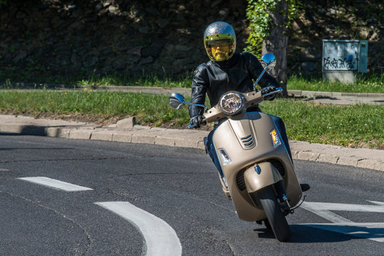 Fototapeta Man riding a classic scooter