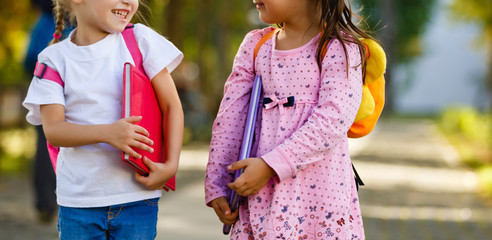 Two little kids going to school together