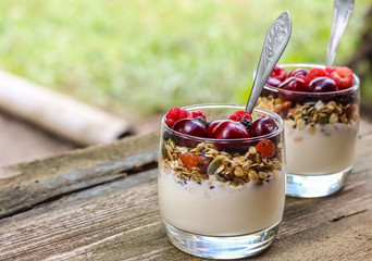 Granola with yogurt and berries in a glass. Delicious healthy American food for breakfast. Traditional US snack. Selective focus