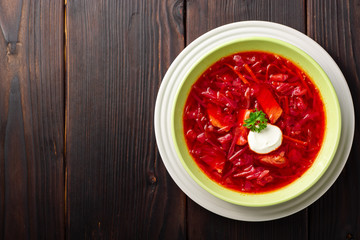 Borsch - traditional Ukrainian and Russian beetroot soup on dark wooden background