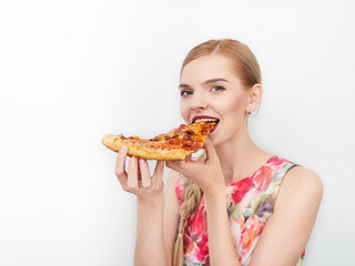 Beauty portrait of young beautiful cheerful young fresh looking woman with bright trendy make up long blond healthy hair enjoying pizza.