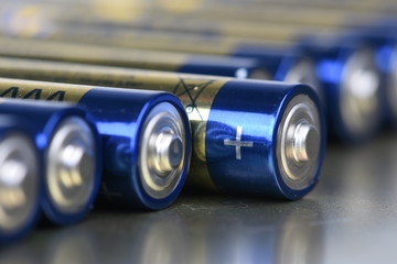 AAA alkaline batteries in perspective on metal background
