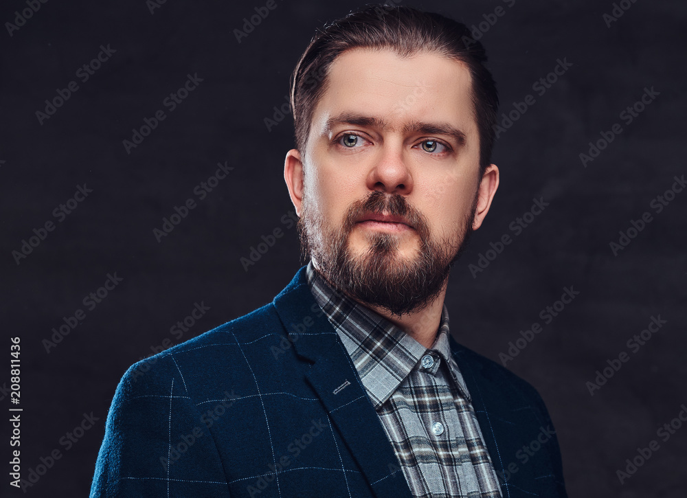 Wall mural close-up portrait of a middle-aged man with beard and hairstyle dressed in an elegant blue suit. iso