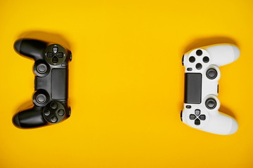 Video game competition. Gaming concept. White and black joystic on yellow backround.