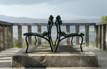 Opposite seats: Benches on a hill near Split, Croatia