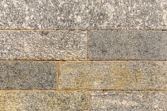 Granite brick wall texture. Architecture abstract background.