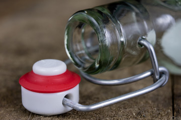 Universal closure of a beverage bottle. Airtight cap closing transparent glass container.