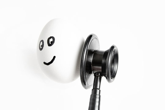 egg with painted eyes and smile. A stethoscope