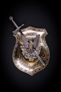 ancient medieval sword and shield on a black background