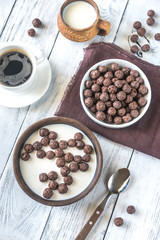 Bowl of chocolate corn balls with milk