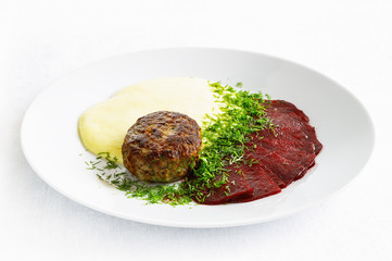 cutlet with potato puree and finely sliced beetroot sprinkled with vinegar and oil decorated with dill