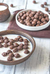 Bowl of chocolate corn balls with milk
