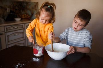 Little kid preparing dough for cookies