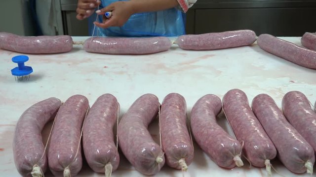 Meat industry, artisanal production of Italian salami. Dolly shot