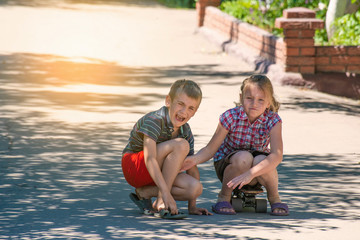 The girl feels sorry for the boy, her brother, who was injured while riding a skateboard on a road...