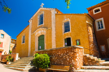 Colorful and ochre church in the Roussillon village, Provence, France