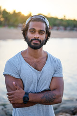 Handsome and confident. Outdoor portrait of smiling young african man on tha beach.